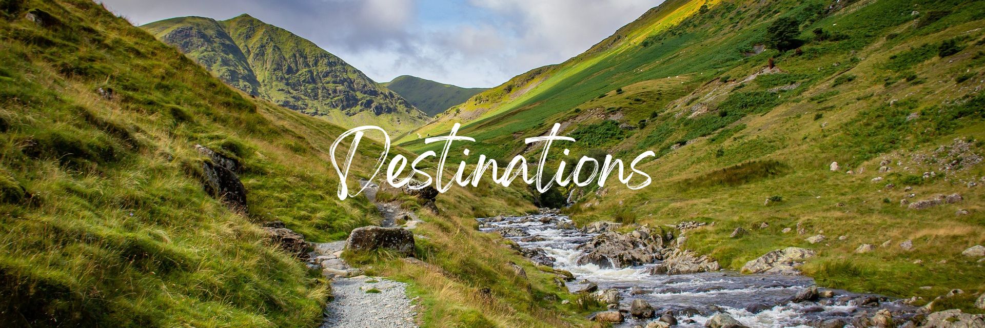 Header image that says "Destinations" with a photo of a hiking trail along a stream in the mountains.